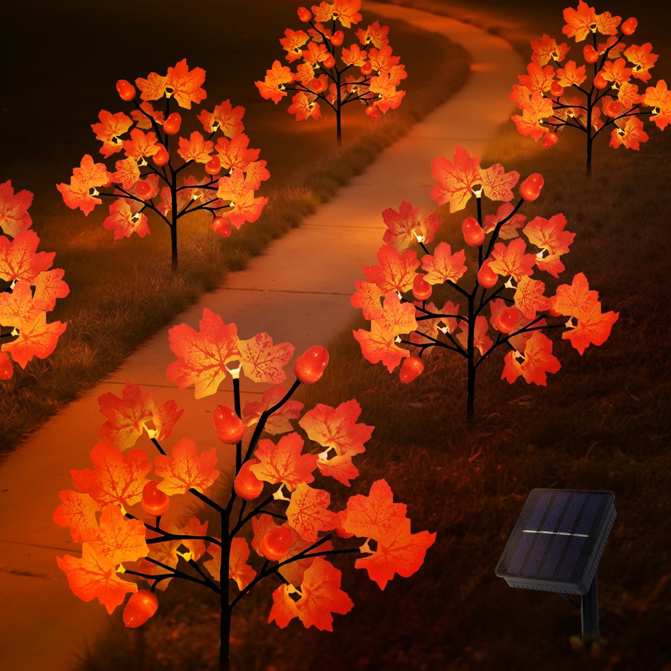 Solar powered maple leaf and acorn yard stake lights illuminating a pathway at night