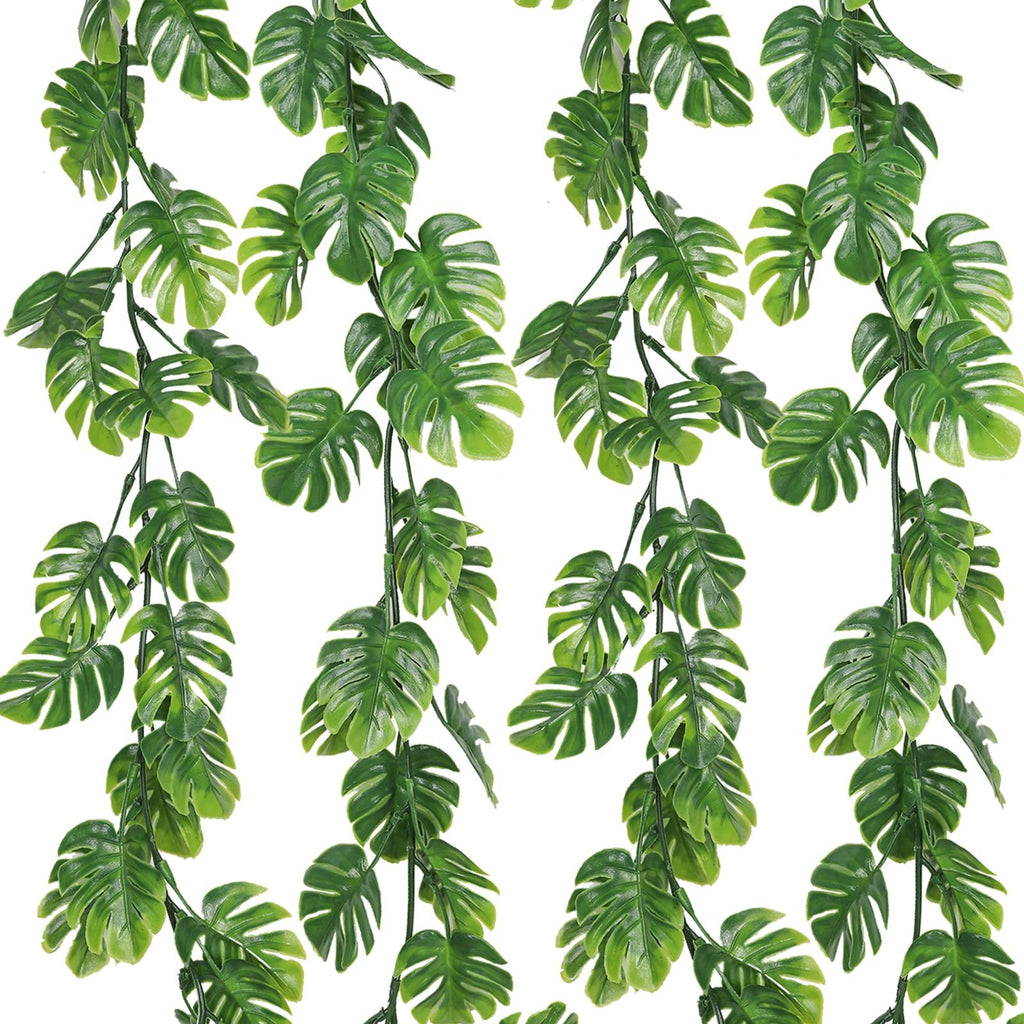 Four artificial monstera vines with green leaves cascading against a white background.