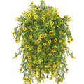 Hanging artificial daisy plant with bright yellow flowers and green foliage, shown from a top-down perspective against a white background.