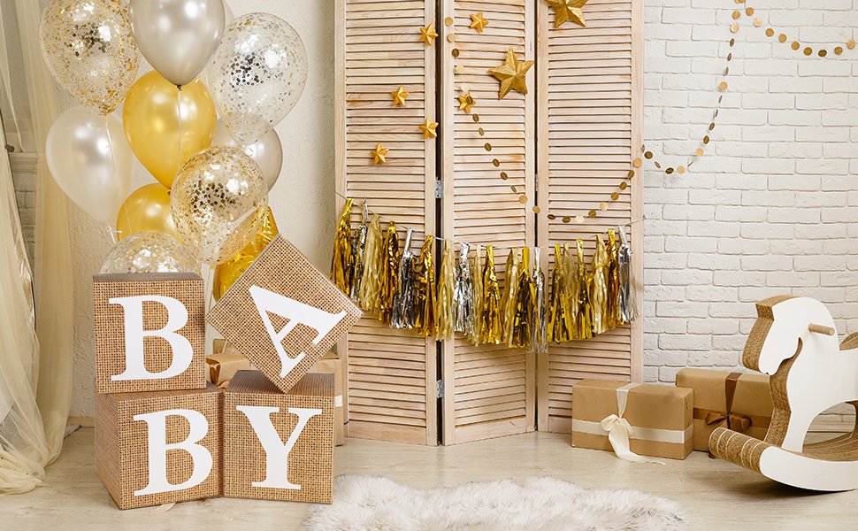 Burlap baby blocks spelling 'BABY' with balloons and party decorations in a rustic farmhouse setting.