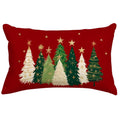 Rectangular pillow cover with a red background featuring a row of Christmas trees in various shades of green and white, adorned with gold stars and snowflakes.