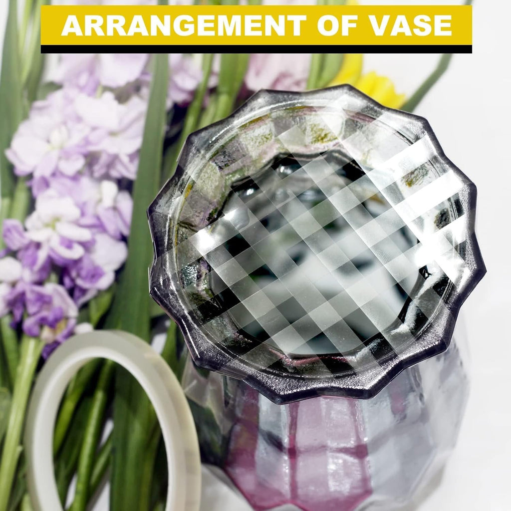 Clear floral tape roll next to a vase with purple and yellow flowers, top view