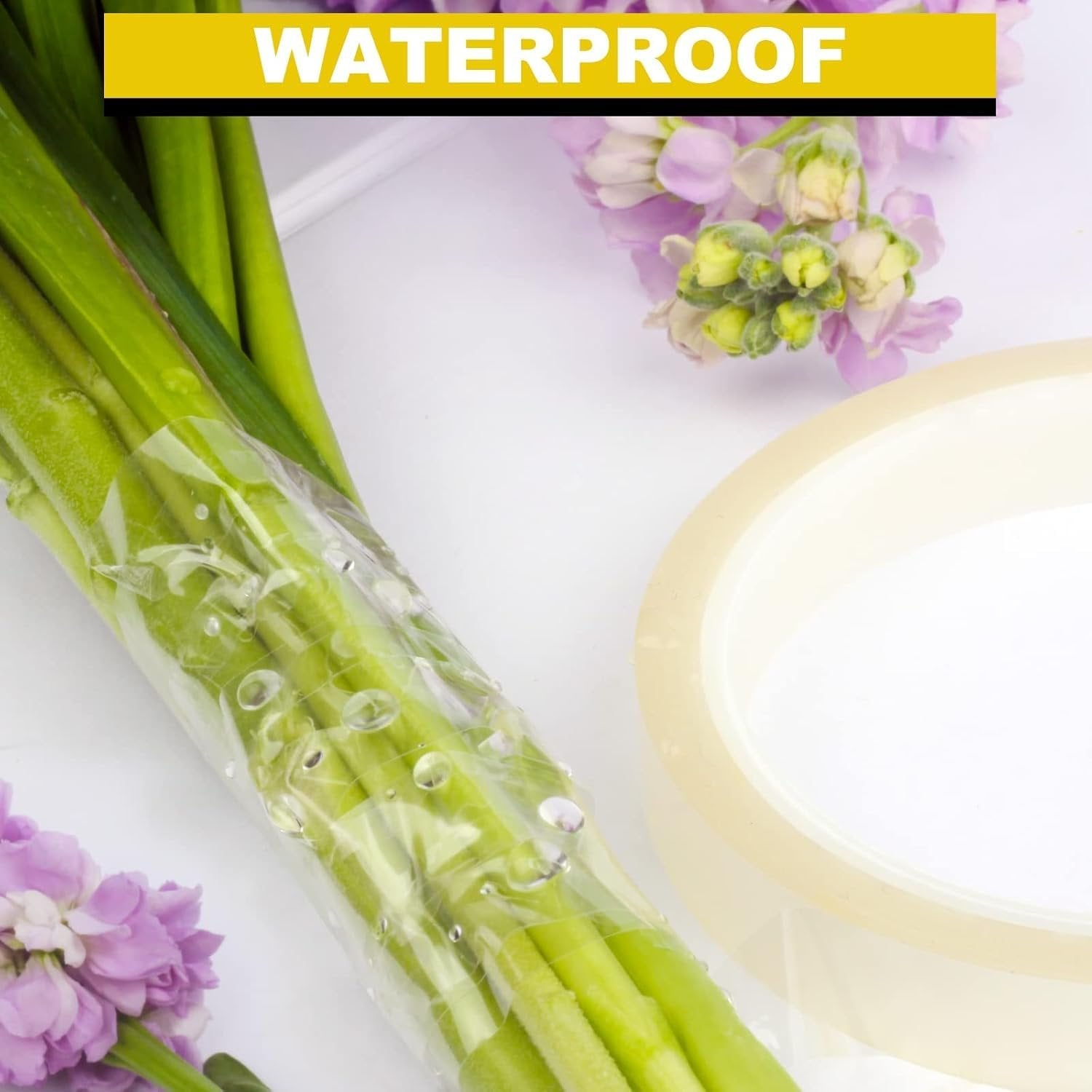 Clear floral tape roll next to a bouquet of green stems and purple flowers with water droplets
