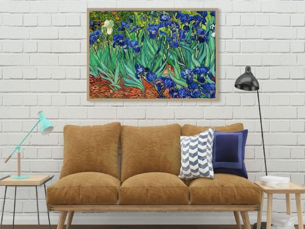 Framed Van Gogh Irises painting displayed above a brown sofa with decorative pillows and a floor lamp.