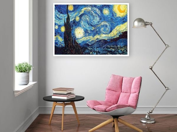 Diamond painting kit of Van Gogh's Starry Night displayed in a modern living room setting with a pink chair and floor lamp.