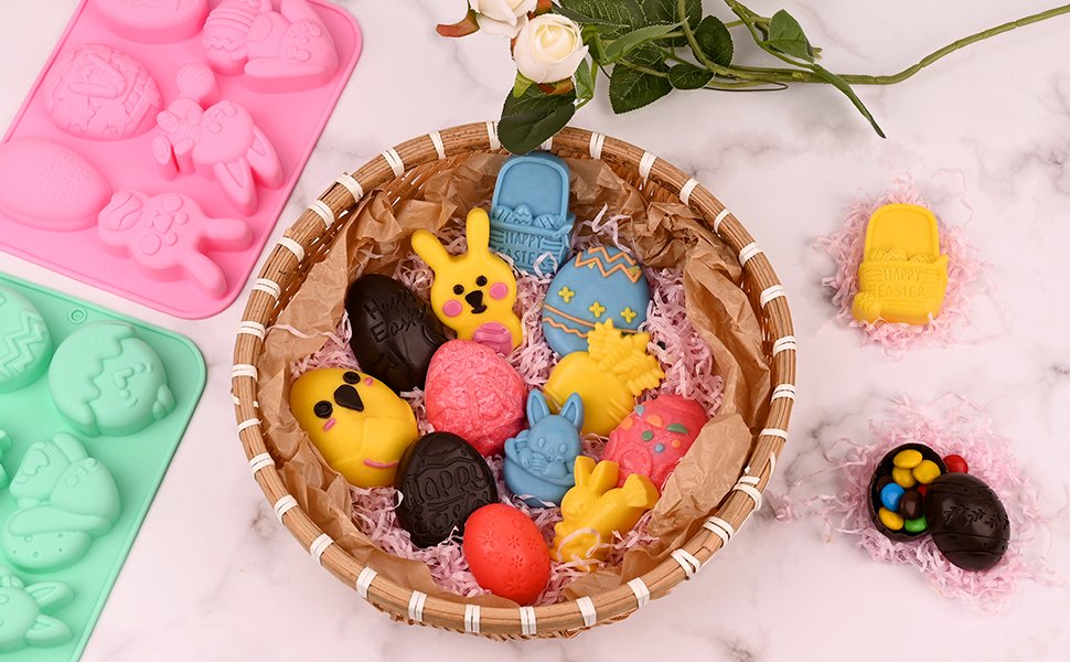 Easter-themed chocolate candies and silicone molds arranged on a marble surface with a basket and flowers.