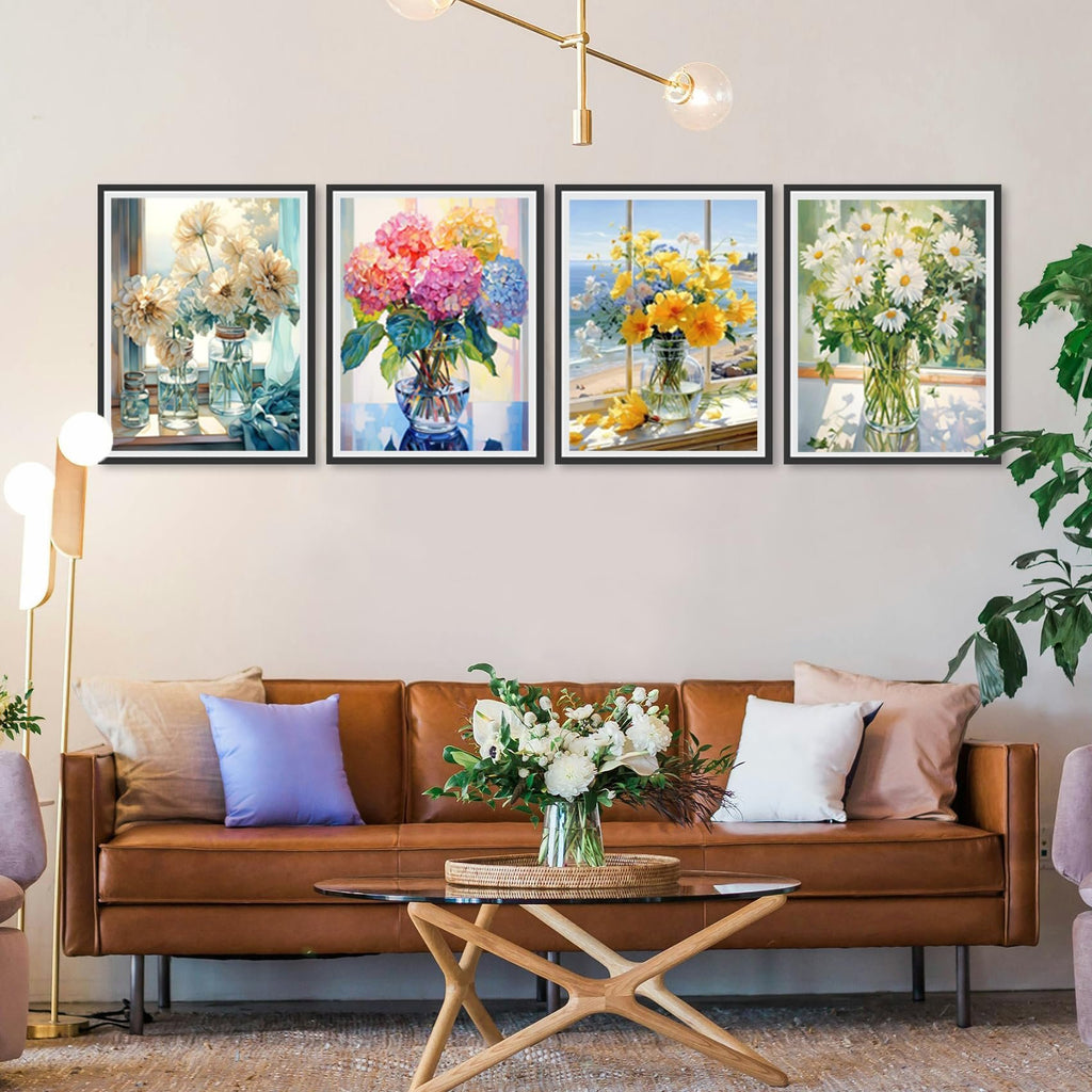 Four framed floral paintings displayed above a brown leather sofa in a living room setting.