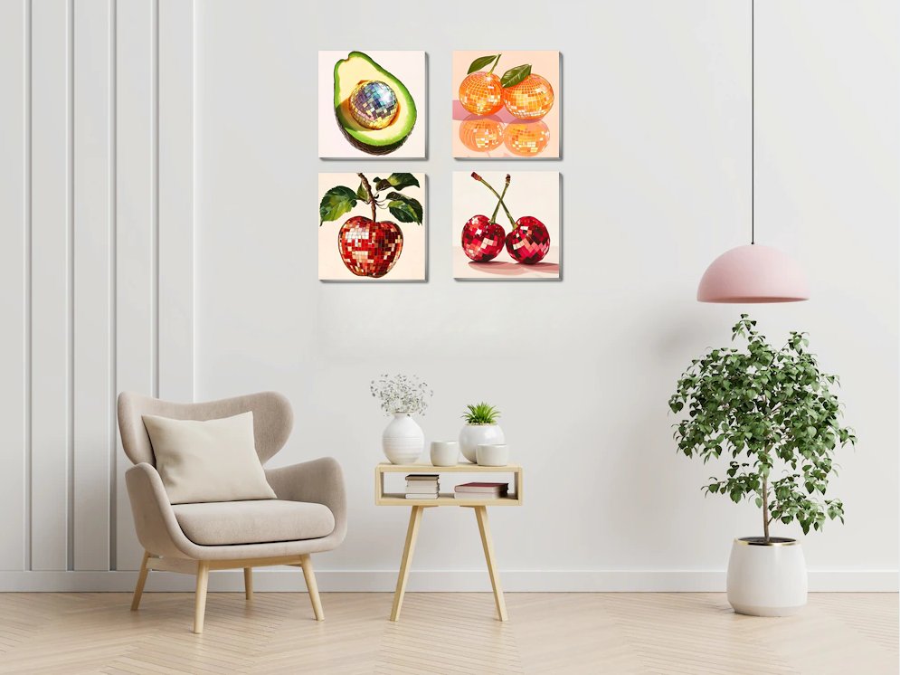 Four framed paint by number canvases depicting disco ball fruits: avocado, oranges, apple, and cherries, displayed on a wall above a chair.
