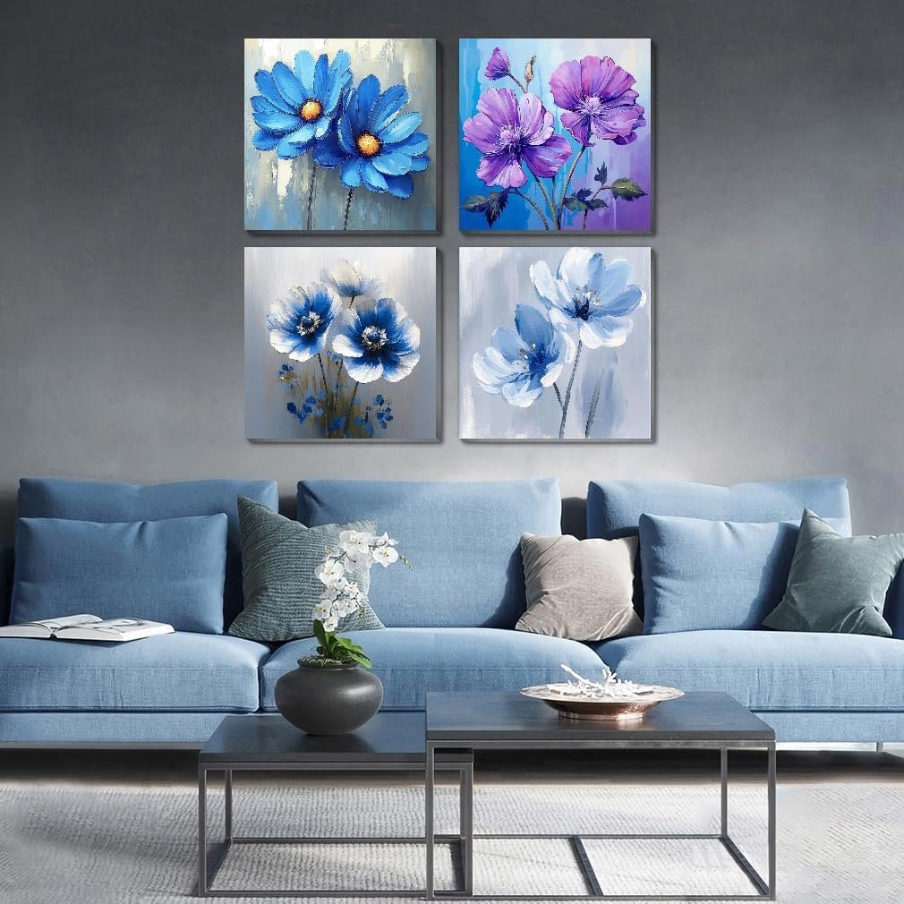 Four framed floral paintings displayed on a gray wall above a blue sofa.