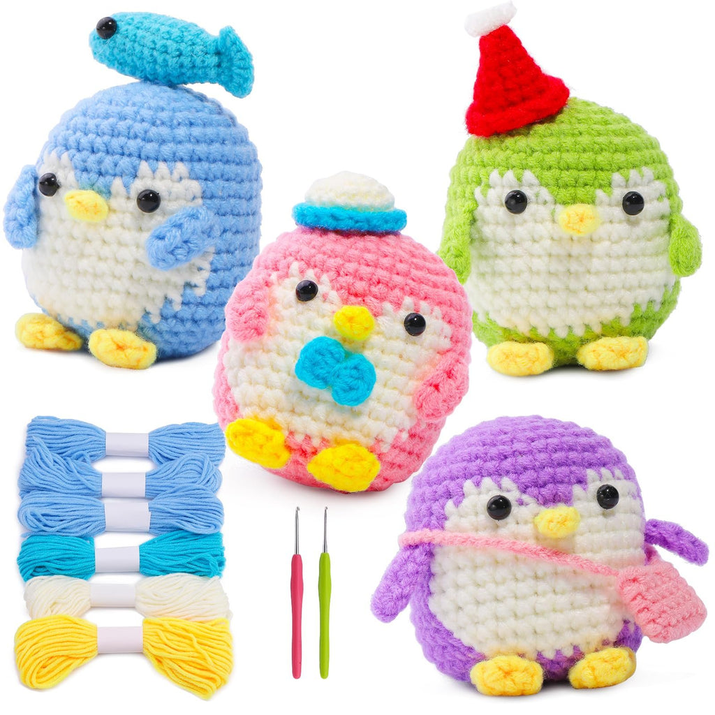 Four crocheted penguins in blue, pink, green, and purple, with yarn skeins and crochet hooks.