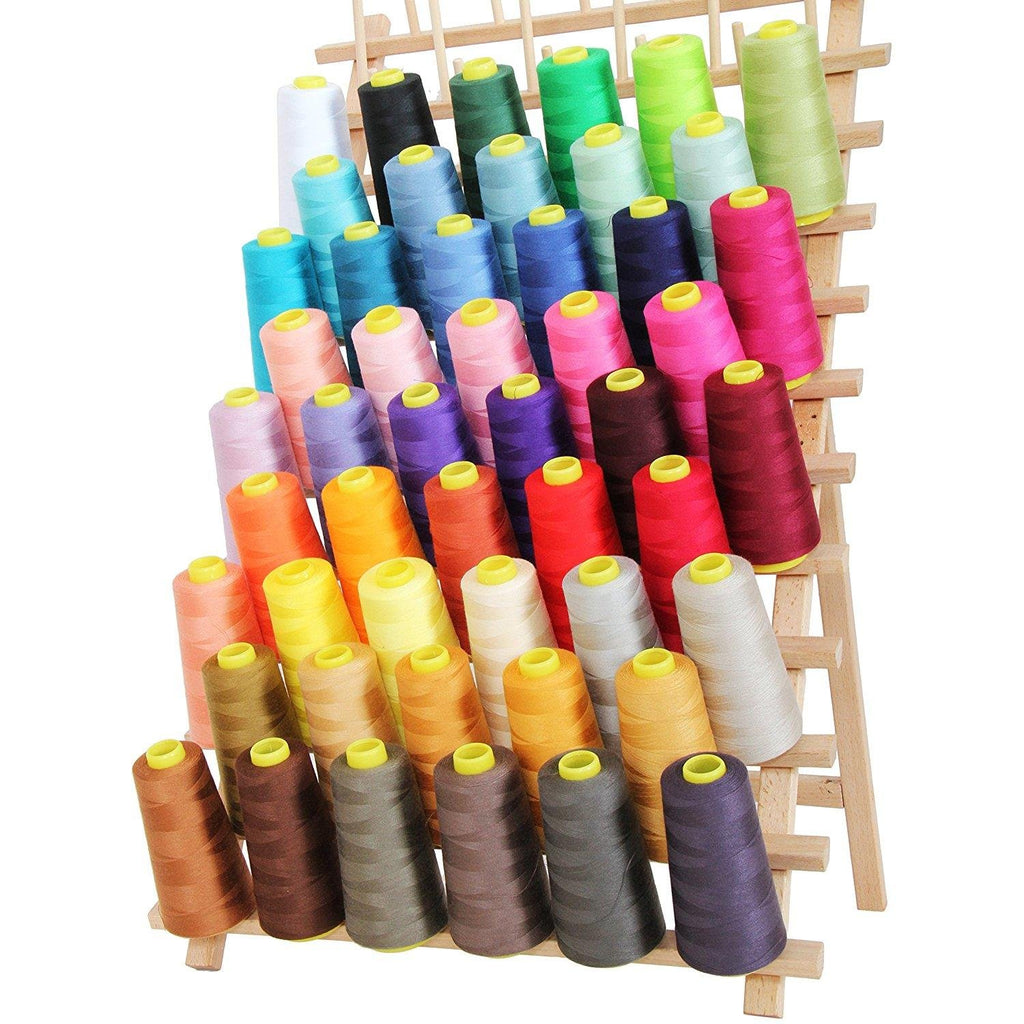 Assortment of colorful polyester sewing thread cones on a wooden rack, angled view.