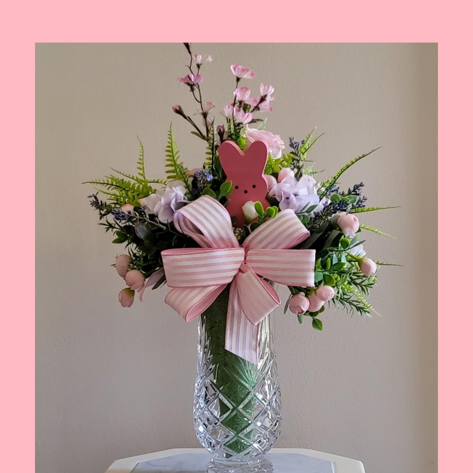 Easter bunny floral arrangement in a crystal vase with pink and white striped bow