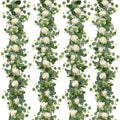 Four artificial eucalyptus and white rose garlands arranged vertically on a white background.