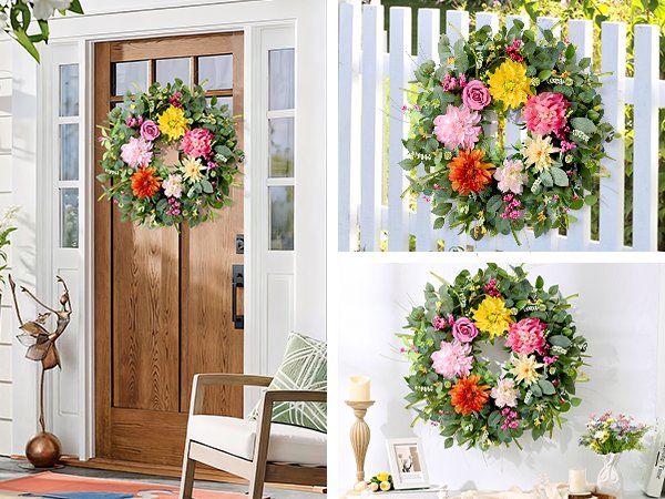 Colorful floral wreath with eucalyptus leaves hanging on a wooden door, white picket fence, and a table with decor.