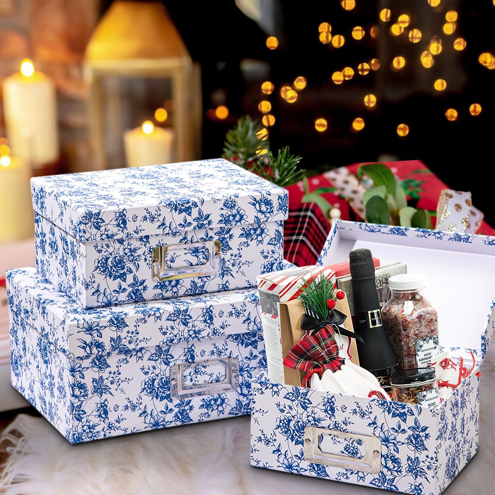 Two blue and white floral storage boxes stacked, one open showing contents like a bottle and jar, with festive background lights.