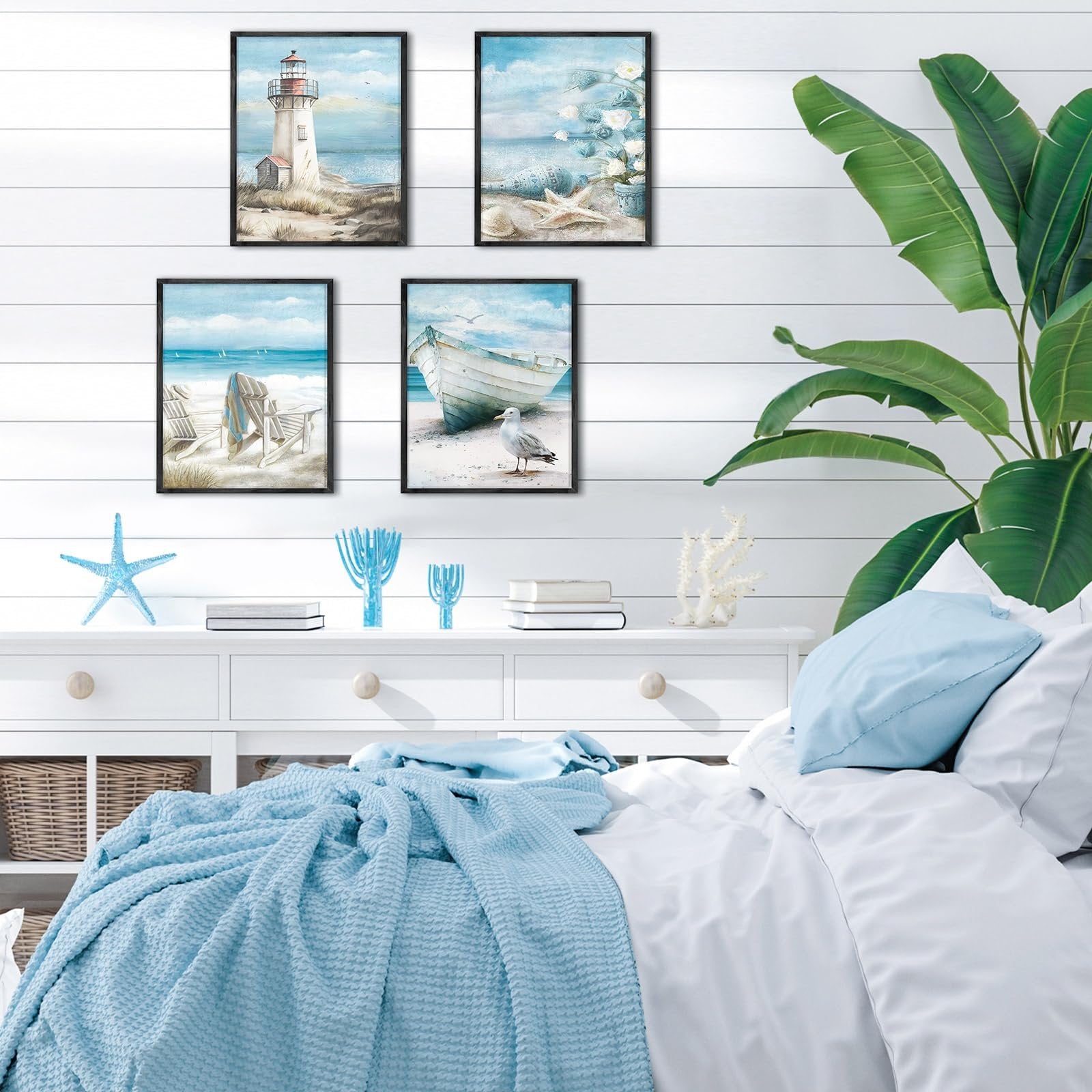 Four framed beach-themed diamond art paintings displayed on a white shiplap wall above a dresser with a bed in the foreground.