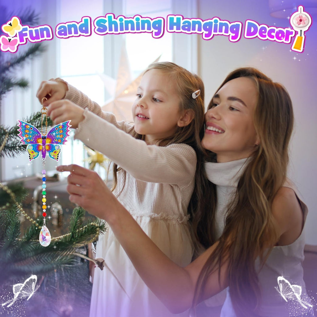 Mother and daughter hanging a colorful diamond painting butterfly wind chime on a Christmas tree.