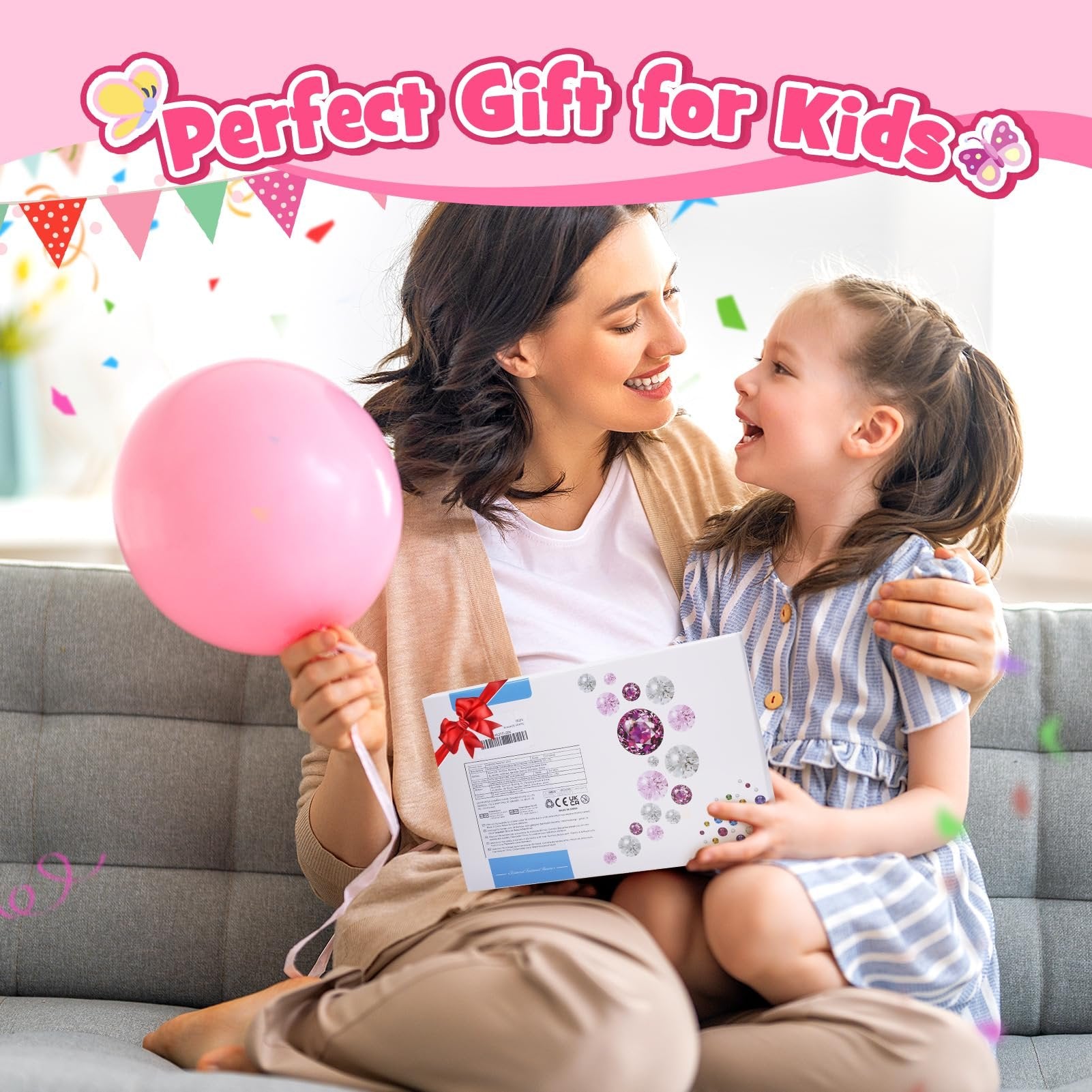Mother and daughter smiling while holding a gift box with diamond painting supplies and a pink balloon.