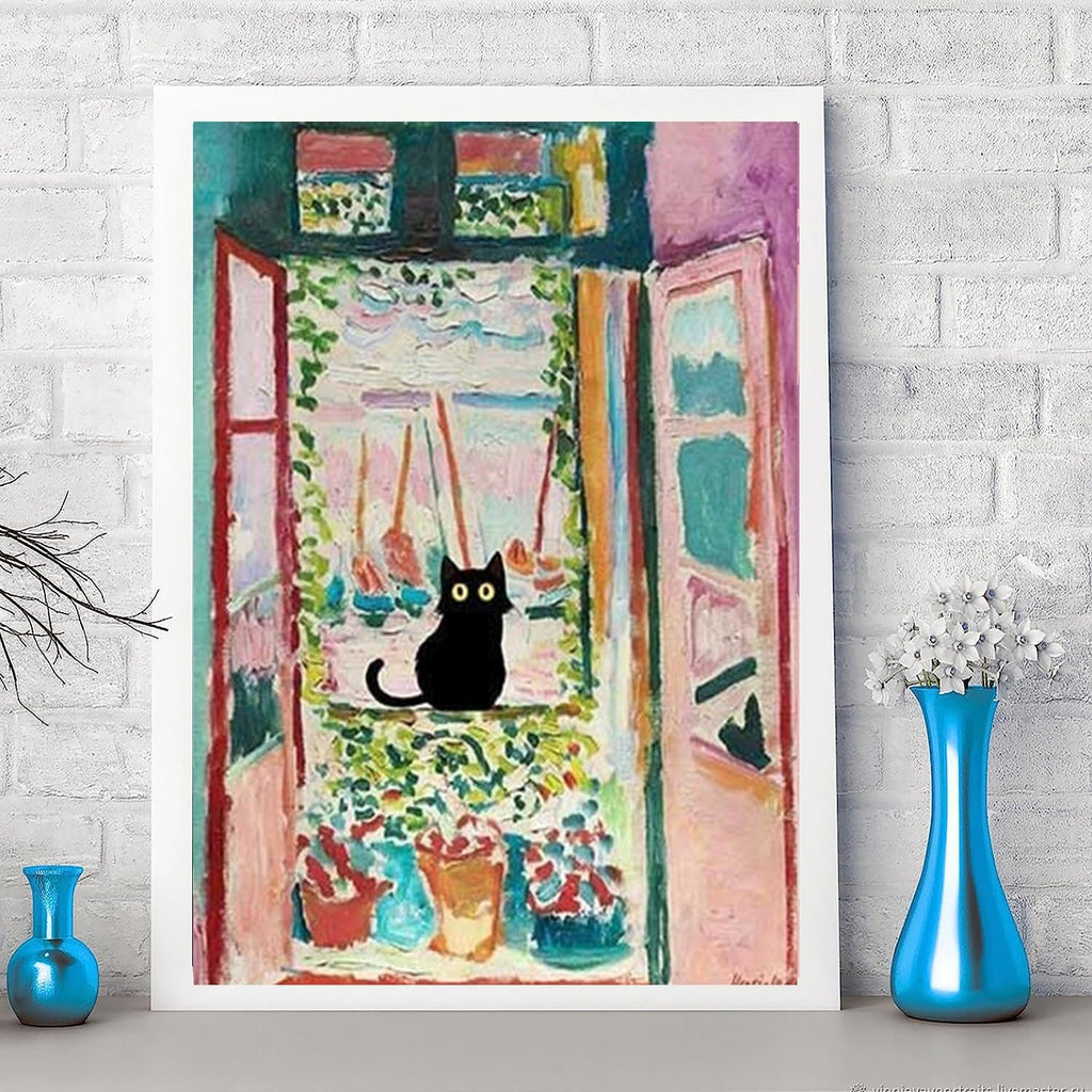 Black cat sitting on a windowsill with potted plants, framed artwork on a brick wall.