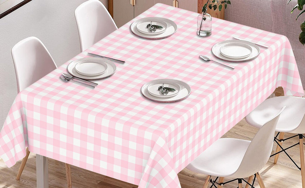 Pink gingham disposable plastic tablecloth set on a table with place settings and chairs