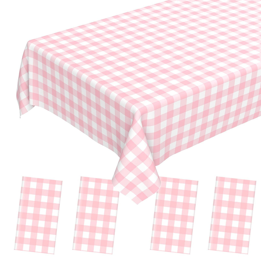 Pink gingham disposable plastic tablecloth and four matching napkins on a white background