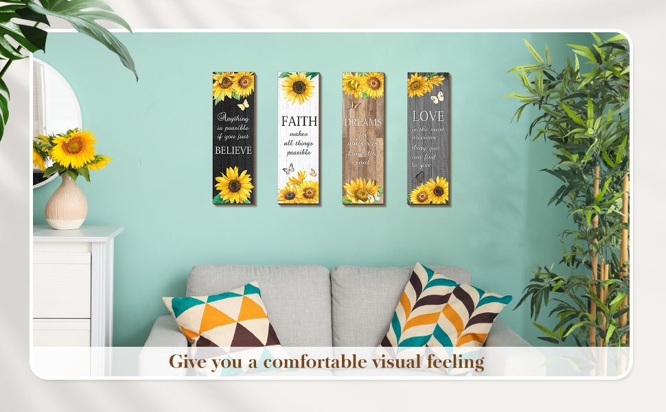 Four sunflower wooden wall decor signs with inspirational quotes displayed above a sofa.