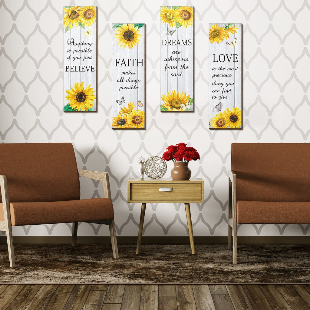 Four vertical wooden wall decor pieces with sunflowers and inspirational quotes, arranged on a wall between two chairs.