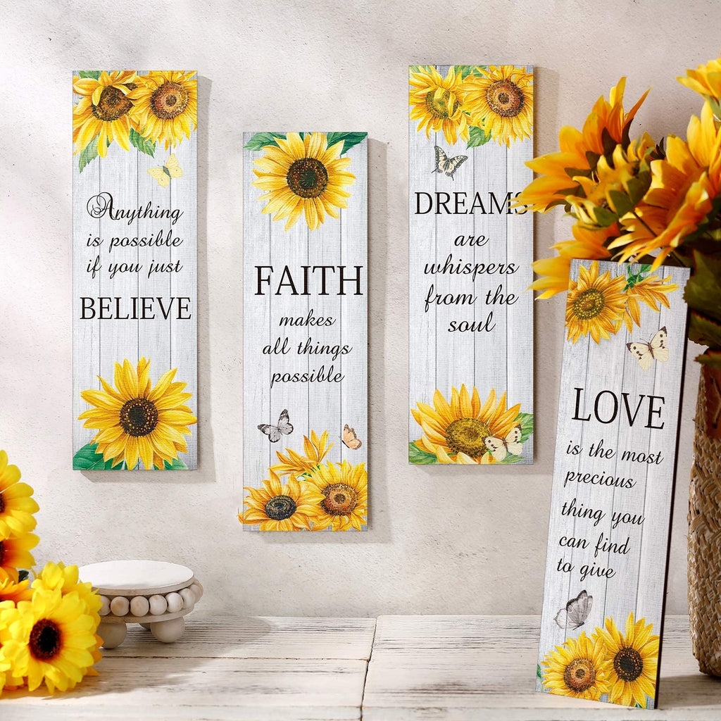 Four wooden wall decor signs with sunflowers and inspirational quotes, arranged on a white wooden surface.