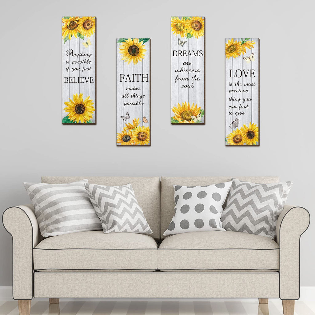 Four wooden wall decor pieces with sunflowers and inspirational quotes displayed above a sofa.