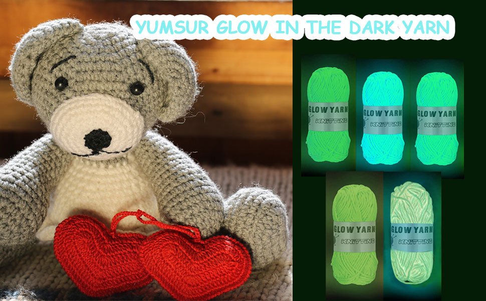 Crocheted gray teddy bear with red hearts and glow-in-the-dark yarn rolls