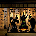 Halloween window clings featuring witches, a black cat, bats, spiders, and a cauldron with green bubbling potion.