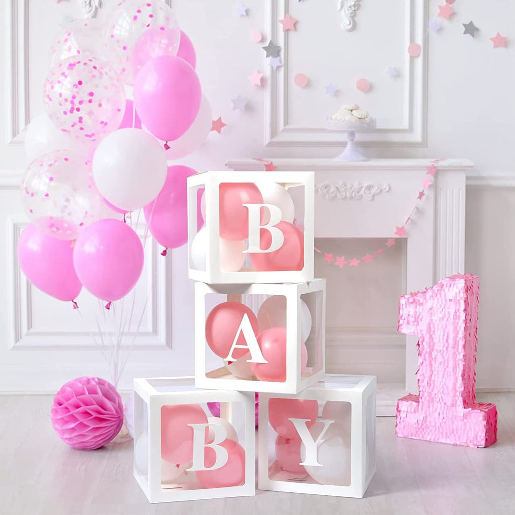 Four transparent white boxes with pink and white balloons inside, spelling BABY, next to a large pink sequined number 1.