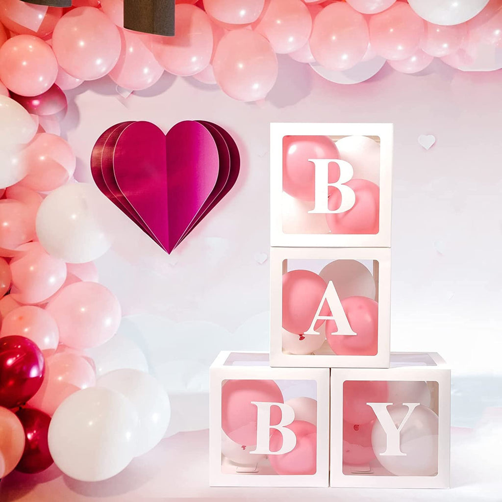 Four white "BABY" boxes filled with pink and white balloons, arranged for a baby shower.