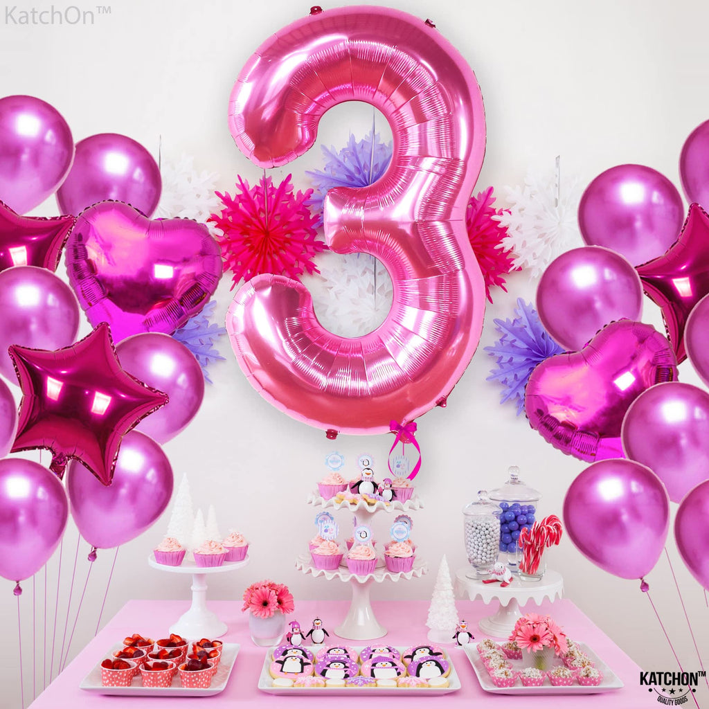 Hot pink number 3 foil balloon with assorted pink balloons and party decorations on a table with cupcakes and cookies.