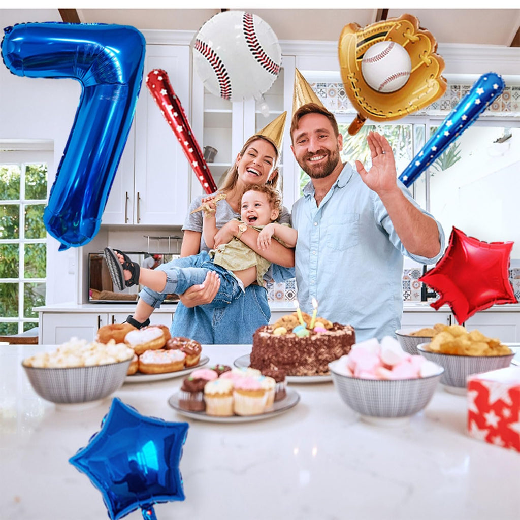Family celebrating a birthday with baseball-themed balloons and party food on a kitchen counter.