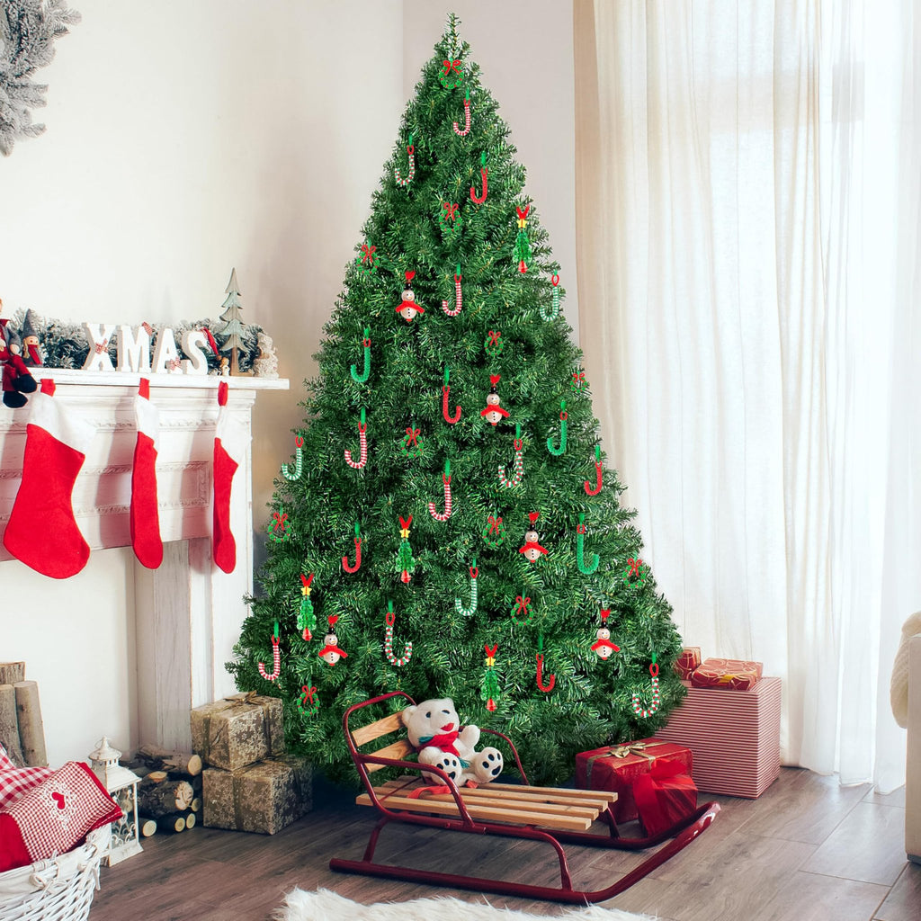 Christmas tree decorated with various ornaments including candy canes, snowmen, wreaths, and trees, with a fireplace and stockings in the background.