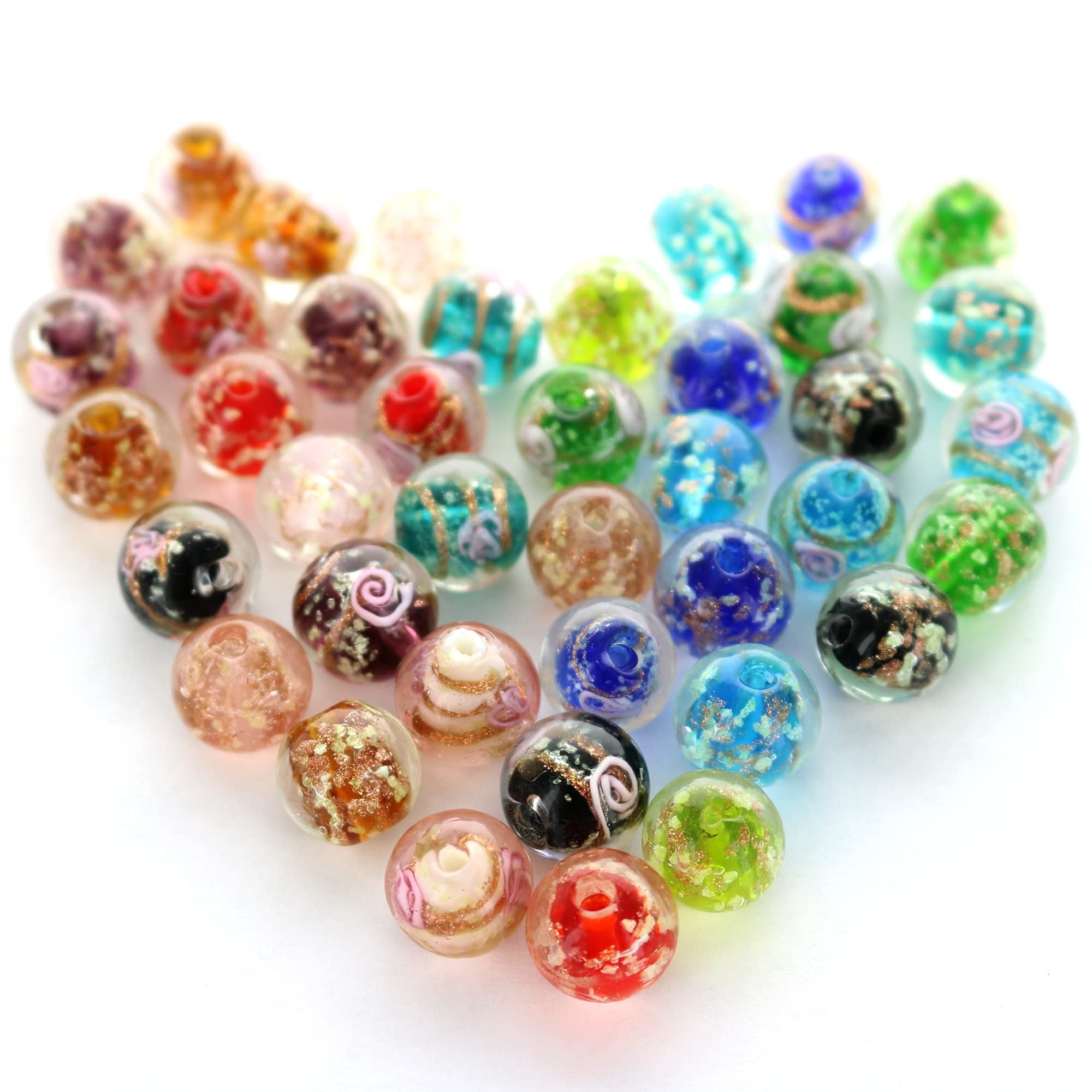 Assortment of 12mm European lampwork glass beads with gold foil and fluorescent sparkles arranged in a heart shape on a white background.