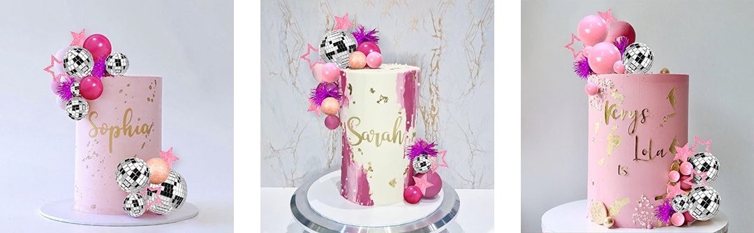 Three pink cakes decorated with disco ball cake toppers, pink balloons, and glitter stars.