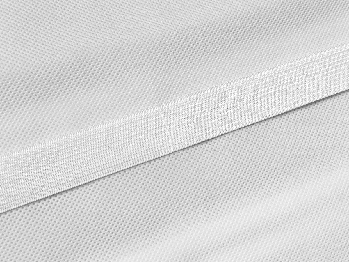 Close-up of white non-woven fabric with a horizontal elastic band detail.