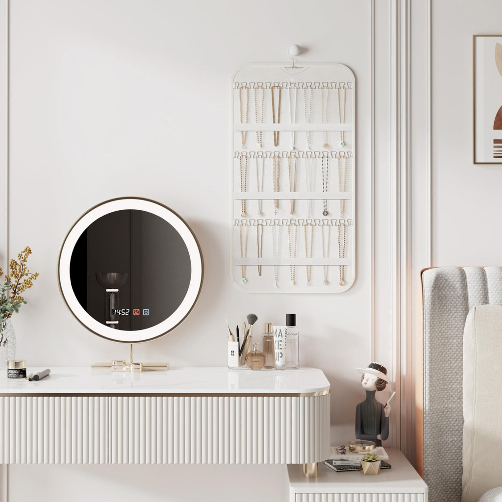 White double-sided hanging jewelry organizer with 40 pockets and 36 hooks, displayed on a wall above a vanity with a lighted mirror.
