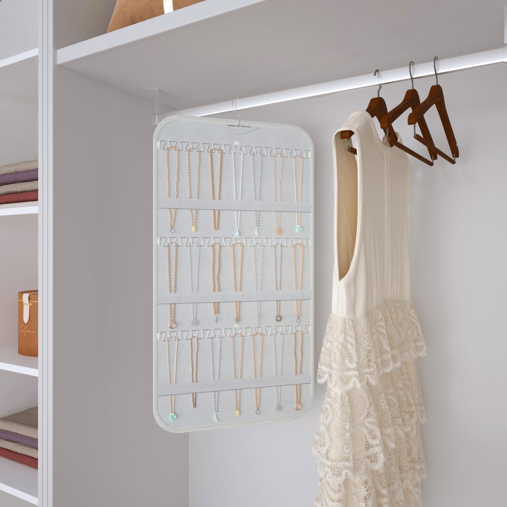 Double-sided hanging jewelry organizer with 40 pockets and 36 hooks, shown in a closet with necklaces displayed.