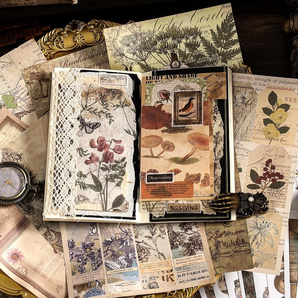 Open journal with vintage nature and floral ephemera pages, surrounded by decorative papers and washi stickers.