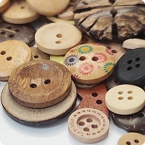 Assortment of mixed vintage wood buttons with 2 and 4 holes, various sizes and natural wood colors.