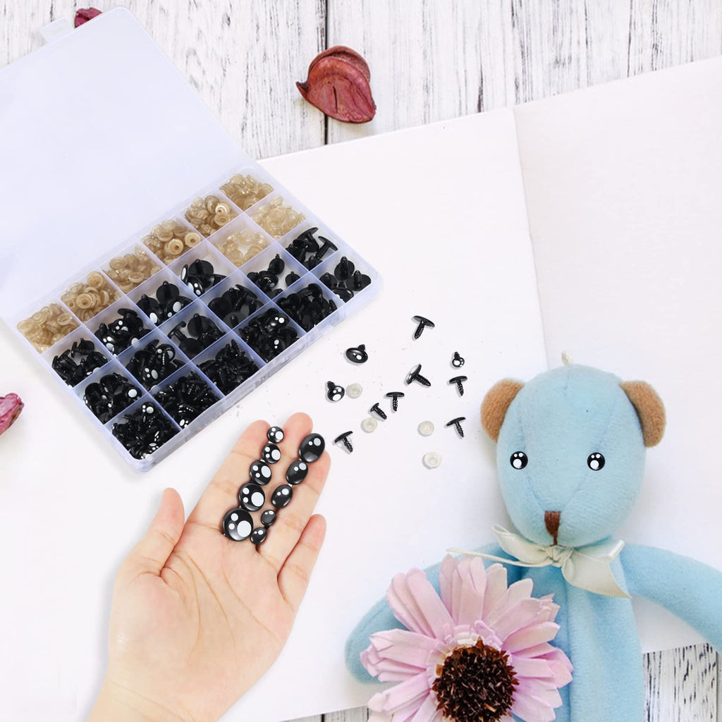 Hand holding black safety eyes and washers next to a divided container of craft eyes and a blue teddy bear.
