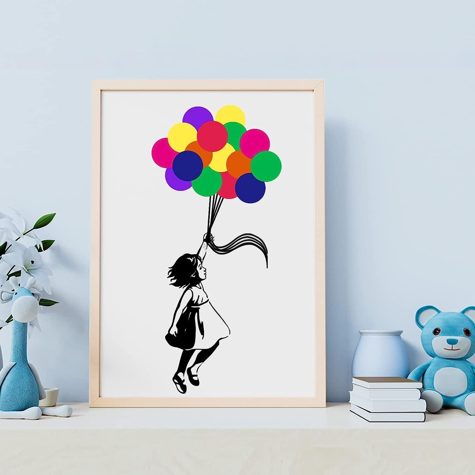 Framed artwork of a girl holding a bunch of colorful balloons, set on a shelf with toys and books.