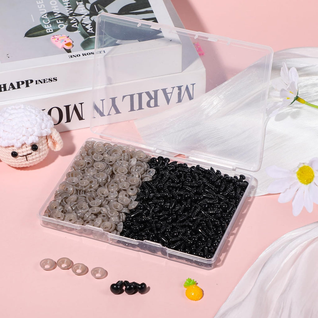 Plastic safety eyes and washers in a clear case, with a crochet sheep and decorative items.