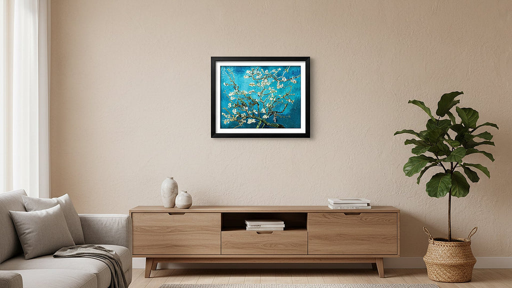 Framed almond blossom diamond painting artwork hanging on a wall above a wooden media console with a sofa and plant.