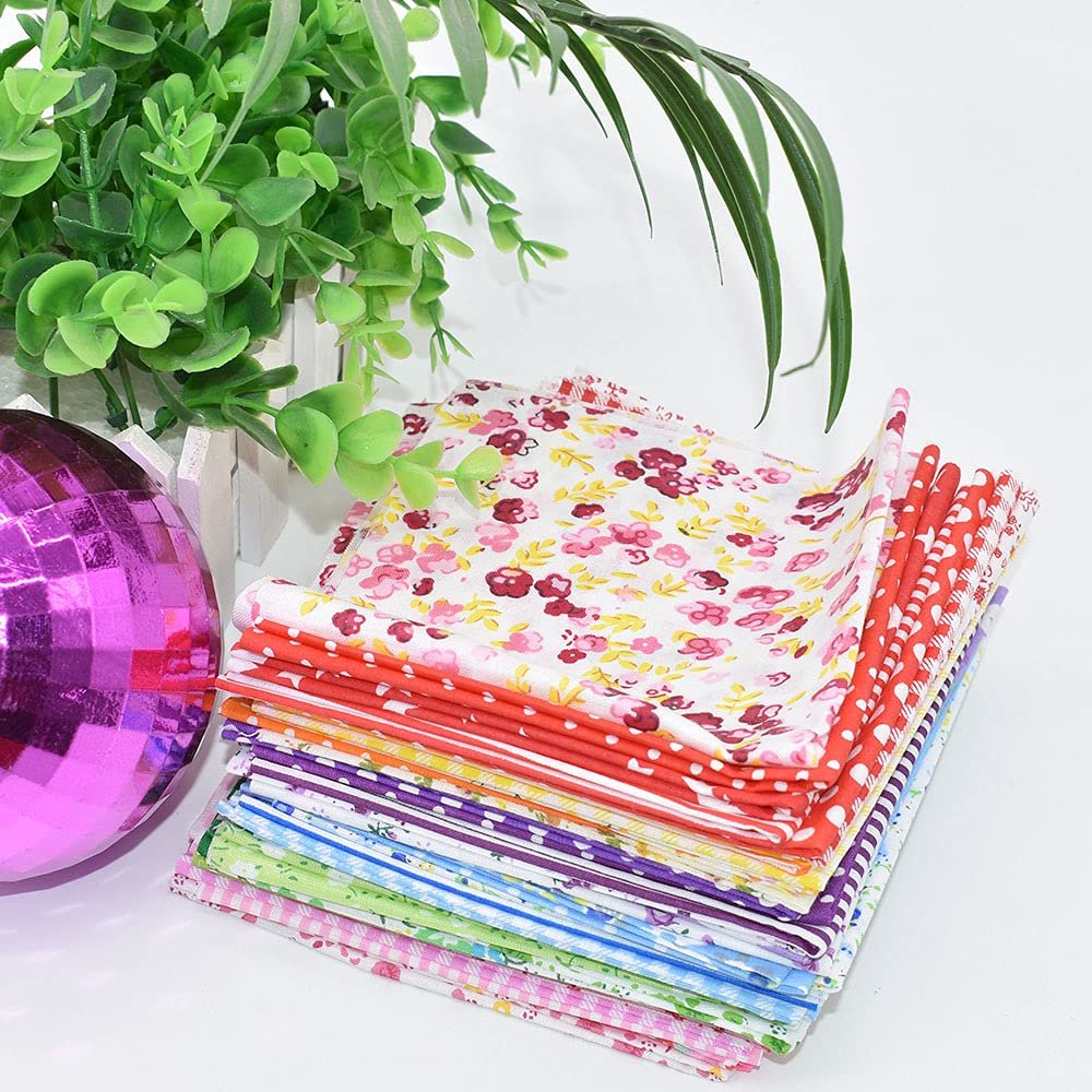 Stack of 10x10 inch floral and polka dot cotton fabric squares with a pink disco ball and green plant.