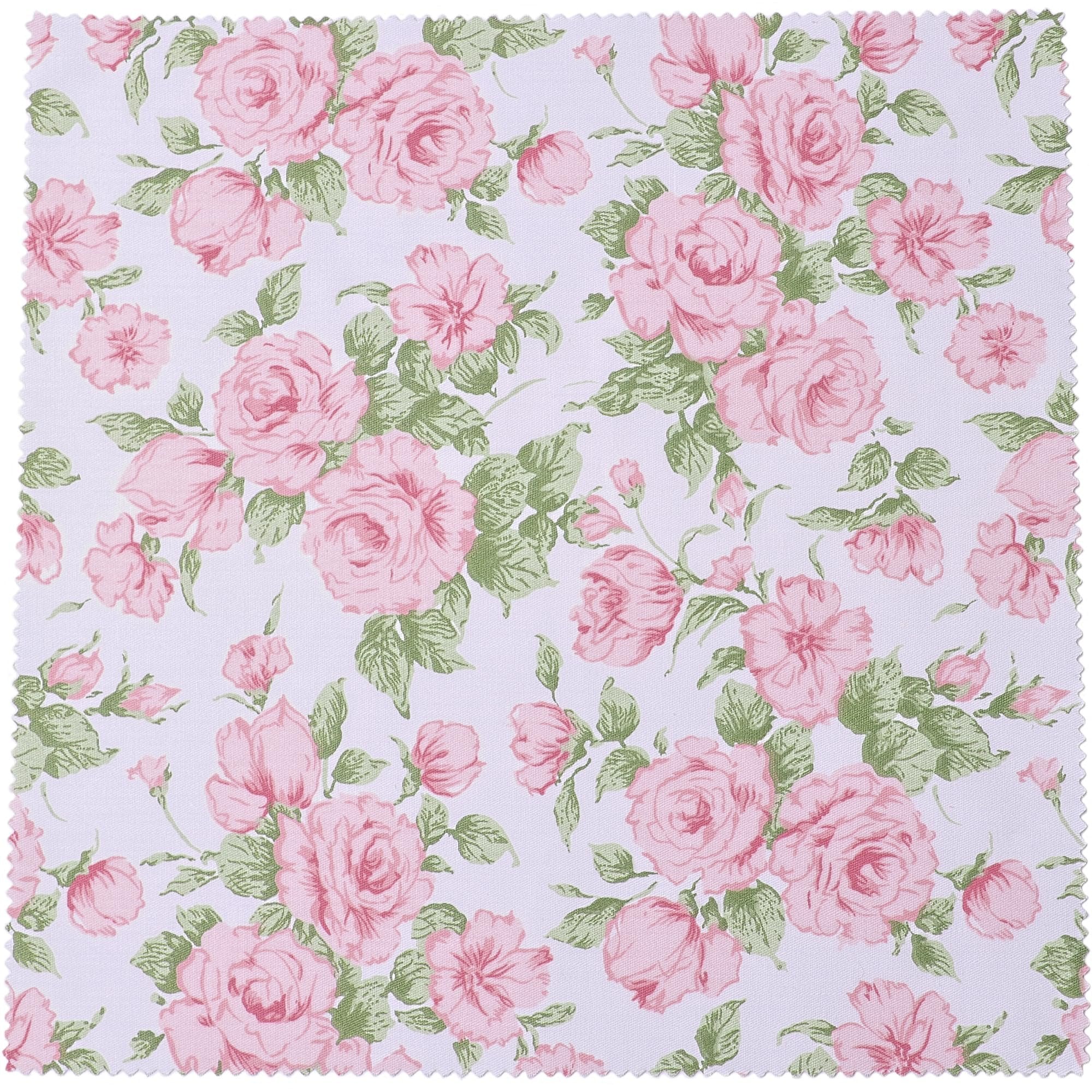 Pink roses and green leaves floral pattern on white fabric swatch with pinked edges