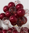 A large cluster of burgundy and confetti balloons arranged in a decorative display.